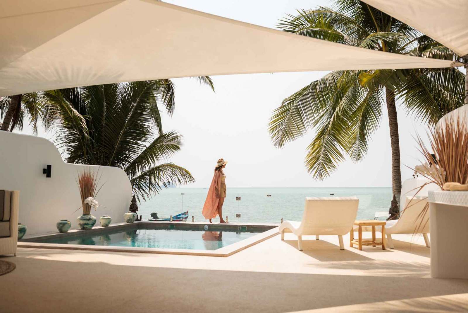 Woman walking along side of luxury pool